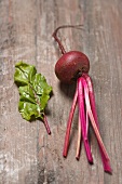 Beetroot with leaves on a wooden surface