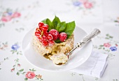 A sponge cake with raspberries and redcurrants