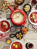 Swiss cheese fondue with potatoes, bread and vegetables (seen from above)