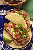 Tacos with beef, avocado sauce and pico de gallo