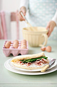 A foam omelette filled with ham and green asparagus