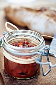 A jar of tomato chutney for a picnic