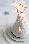 A Christmas tree cake with a sparkler