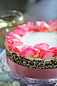 A wedding cake with rose petals