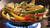 Sautéing vegetables in a frying pan