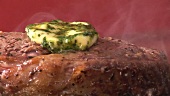 Peppered steak with melting herb butter