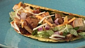 Taco shell filled with chicken and cheese