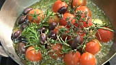 Frying tomatoes, garlic, olives and herbs