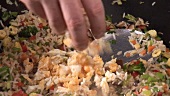 Cooking vegetable rice in a wok, adding egg