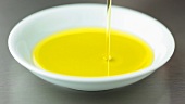 Pouring olive oil into a dish