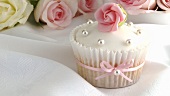 Cupcake with marzipan rose and silver dragees