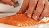 A salmon fillet being deboned (English Voice Over)