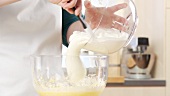 Beaten egg white being folded into mascarpone cream