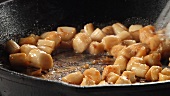 Scallops being fried