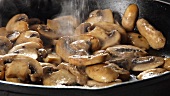 Mushrooms being fried in a pan