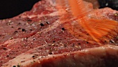 Steak mit Marinade einpinseln