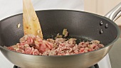 Minced meat being fried in a pan