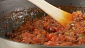 Minced meat sauce being stirred