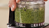 Pesto ingredients being mixed together
