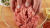 Minced meat being placed in a bowl