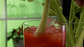 Tomato juice garnished with a stick of celery
