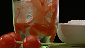 Tomato juice being added to vodka and lemon juice