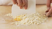 An egg being added to a butter-flour mixture