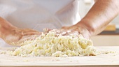 Cooked potatoes being mixed with flour and egg