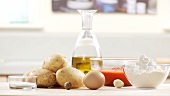 Ingredients for gnocci with tomato sauce: potatoes, egg, flour, tomato sauce, olive oil