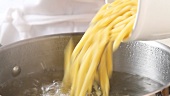 Pasta being placed in boiling water