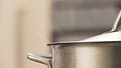 A steaming pot with a lid