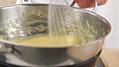 Egg cream being stirred over a bain marie