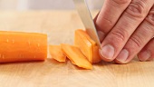 A carrot being chopped