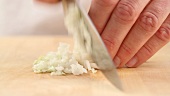 An onion being finely chopped