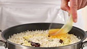 Saffron solution being added to rice