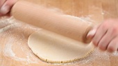 Yeast dough being shaped into a roll