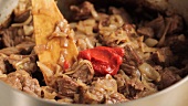 Beef goulash being prepared (German Voice Over)