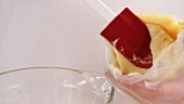 Choux pastry being poured into a piping bag