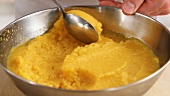Passion fruit sorbet being scooped out with a spoon