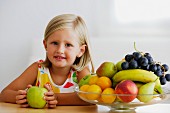 Little girl and full fruit bowl