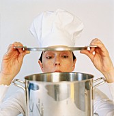 Cook lifting lid of pan