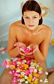 Young woman in a rose petal bath