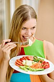 Young woman eating crudités