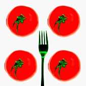 Four tomatoes and a green fork