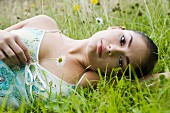 Young woman lying in flowery meadow