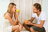 Young couple eating fruit