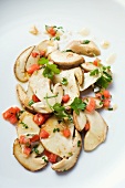 Fried porcini mushrooms with diced tomatoes and parsley