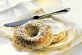 Sliced Multi-seed Bagel on Plate with Cream Cheese