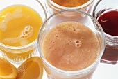 Assortment of Four Friut and Vegetable Juices in Glasses