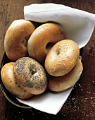 Assorted Bagels on a Cloth in a Bowl